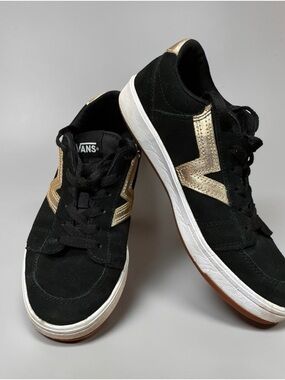 Vans Black Low-Top Sneakers with Gold Accents.